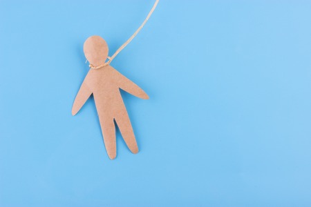 hang oneself concept. paper person on blue backgroundの写真素材