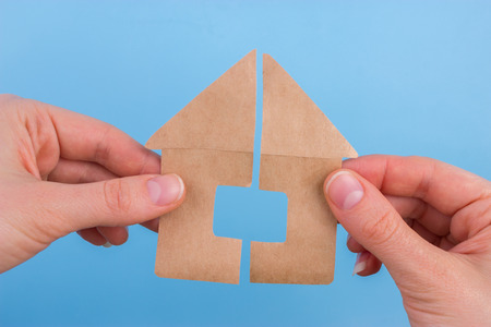 property division concept. scissors cut paper houseの写真素材