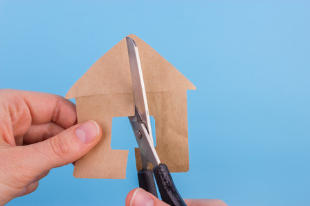 property division concept. scissors cut paper houseの写真素材