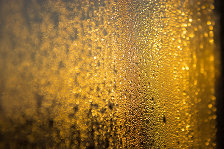 yellow color background. water drops and sunlight on the windowの写真素材