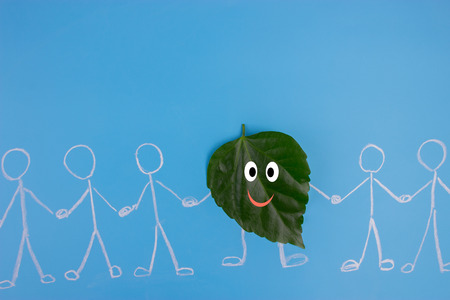 leaf character holding hans with people. environmental conceptの写真素材