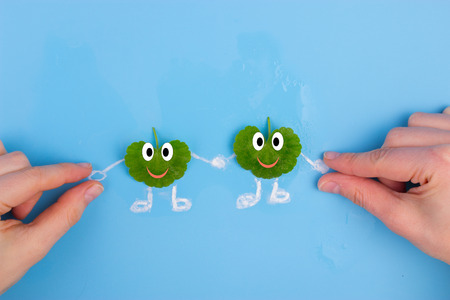 leaf character holding hans with people. environmental conceptの写真素材