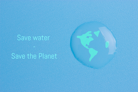 Earth in water drop reflection on blue backgroundの写真素材