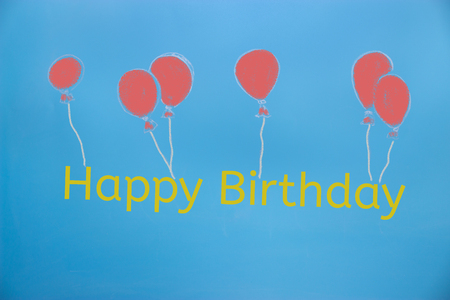 creative happy birthday concept on blue backgroundの写真素材