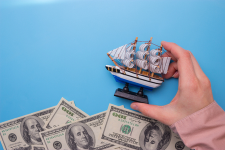 ship floating on waves, made from dollar billsの写真素材