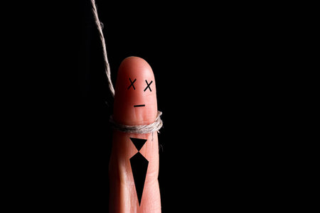 Concept of finger puppet with noose around his neckの写真素材