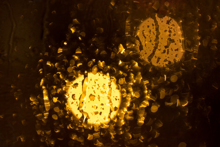 Drops of rain on window, night. blurred lightの写真素材