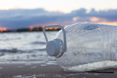 Plastic water bottles pollute ocean. bottle on the cost