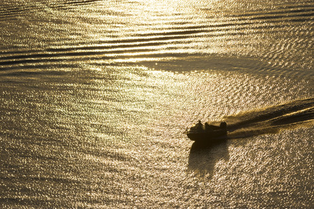 small boat in the river in sunset light