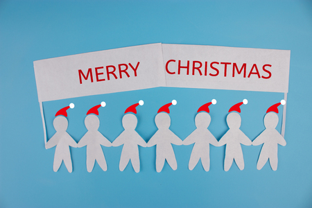 Paper people holding a sign. christmasの写真素材
