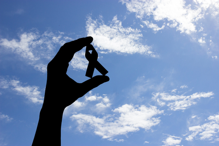 hand holding cancer awareness ribbonの写真素材