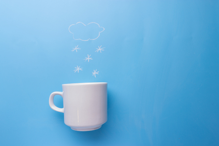 Woman hands in mittens hold cupの写真素材