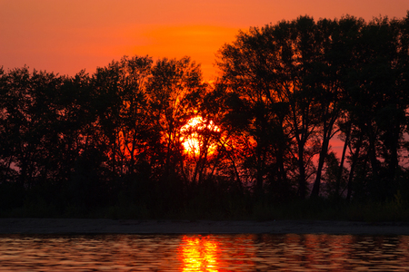 Sunset on the lake. water and beautiful colored skyの写真素材