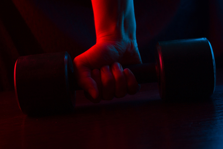 metal barbell on dark background in neon lightの写真素材