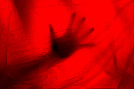 hads behand red curtains. horror halloween conceptの写真素材