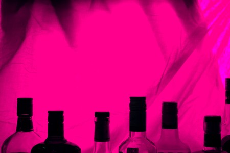 alcohol bottle on red backround. copy cpaceの写真素材