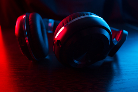 headphones on dark background in neon lightの写真素材