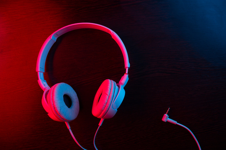 headphones on dark background in neon lightの写真素材