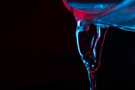 Red and blue neon background from water flow. defocused