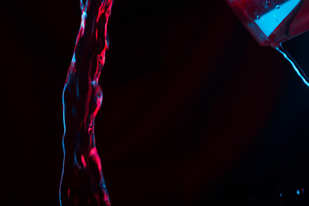 Red and blue neon background from water flow. defocusedの写真素材