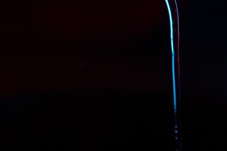 Red and blue neon background from water flow. defocused