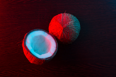 coconut in red and blue light. dark backgroundの写真素材