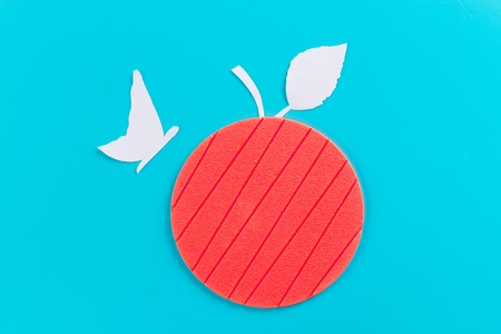 butterfly on an apple. made of paperの写真素材