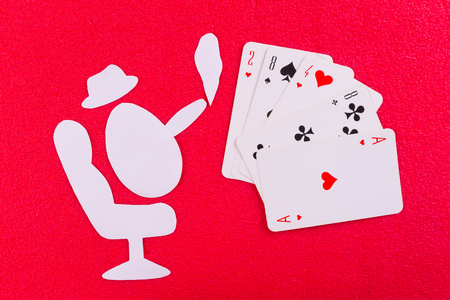 Playing cards near wineglass of whiskey and cigar. paper cut