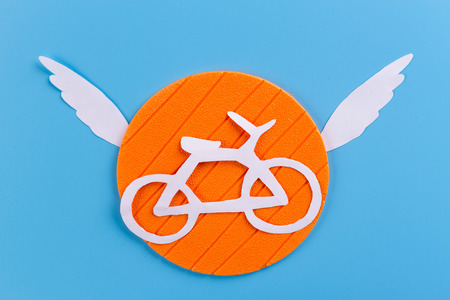 paper bicycle with winds on blue backgroundの写真素材