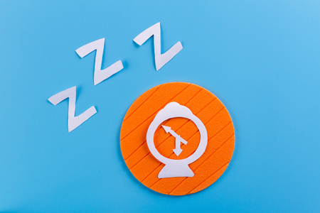 Alarm clock on color background. made of paperの写真素材