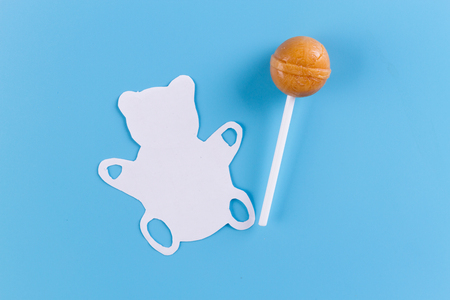 Teddy bear and lollipop. sweets concept. blue backgroundの写真素材