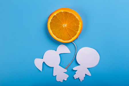 orange on blue background. healthy eating conceptの写真素材