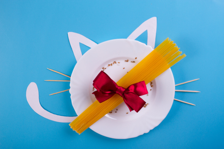 raw pasta in a plate on the blue backgroundの写真素材