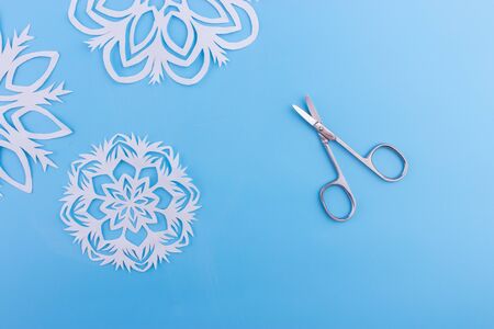 snowflakes made of paper on the blue backgroundの写真素材