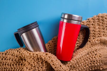 two thermomugs on blue background. winter time conceptの写真素材