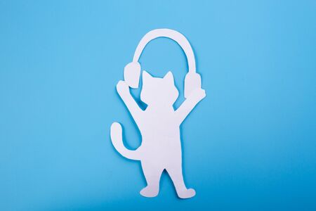 Cute kitten and headphones. Young cat is listening to music with headphones