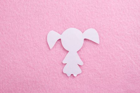 Young girl child paper art. pink backgroundの写真素材
