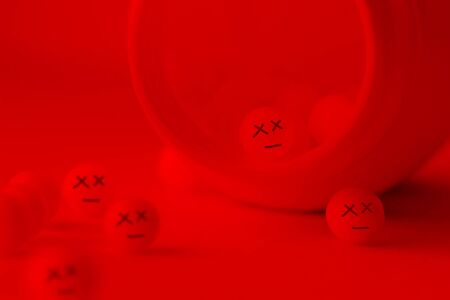 Pills with dead faces. poisonous pills conceptの写真素材