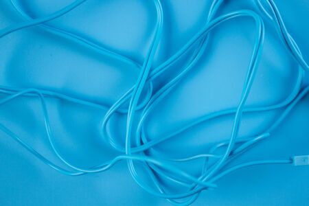 Blue headphones on blue background. Close upの写真素材