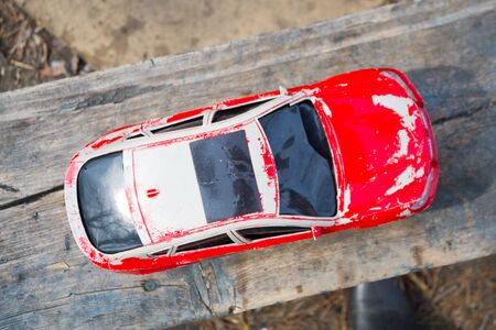 Old red toy car. Childhood problems conceptの写真素材