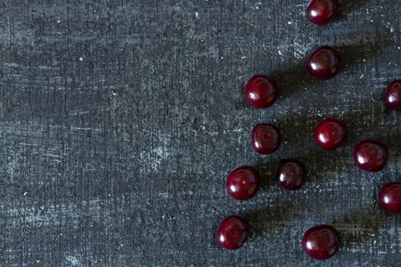 Fresh cherry on black background. Flat layの写真素材