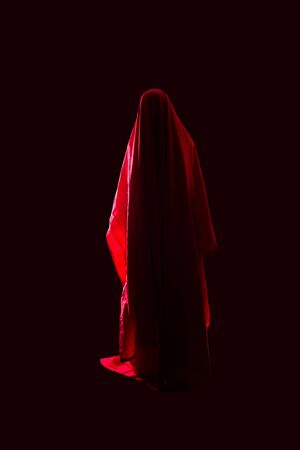Scary person in red dress over black backgroundの写真素材