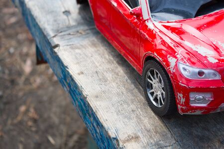 Old red toy car. Childhood problems conceptの写真素材
