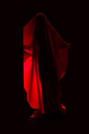 Scary person in red dress over black backgroundの写真素材
