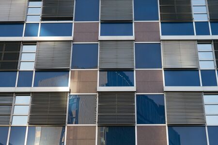 close up of skyscraper window. Blue colored