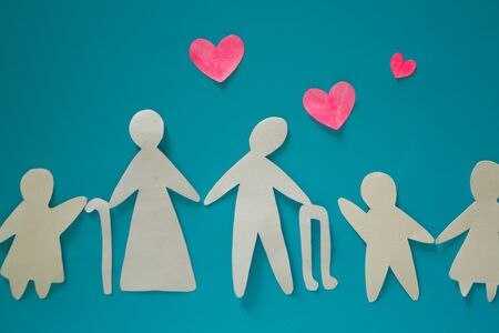 Paper cut of grandparents with granchildren. Blue background