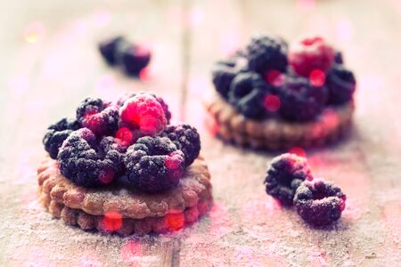 Cookie with raspberry on rustic wooden backgroundの写真素材
