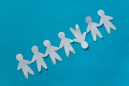 Think differently concept image. Paper people standing on their heads