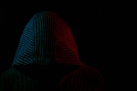 Portrait of Invisible man in the hood on black backgroundの写真素材