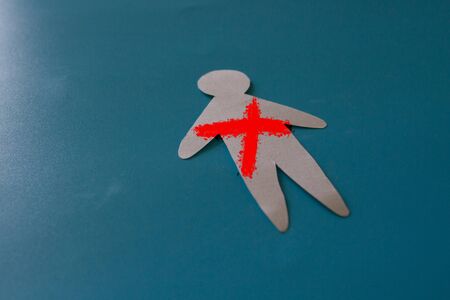 Murder concept image. Paper man with cross mark on him